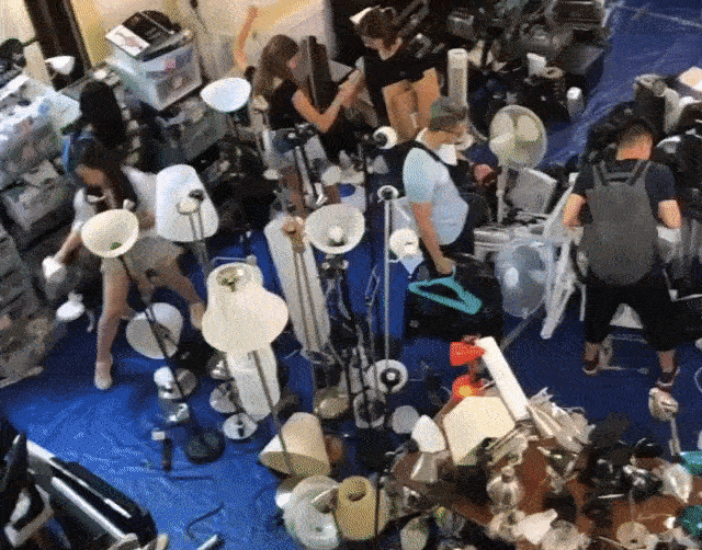 A green rectangle has the Columbia Ecoreps logo in the center. When hovered over, a gif plays. The gif shows a panning shot over a large room filled with belongings for sale. It is the Green Sale, held annually during move in to help students find low-cost pre-loved dorm room supplies, decorations, and textbooks.